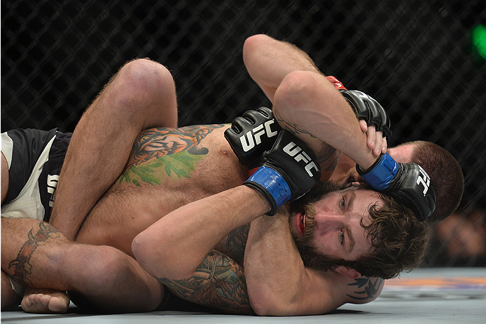 LAS VEGAS, NEVADA - DECEMBER 10: (Back) Jim Miller attempts a submission on Michael Chiesa in their lightweight bout during the UFC Fight Night event at The Chelsea at the Cosmopolitan of Las Vegas on December 10, 2015 in Las Vegas, Nevada. (Photo by Br