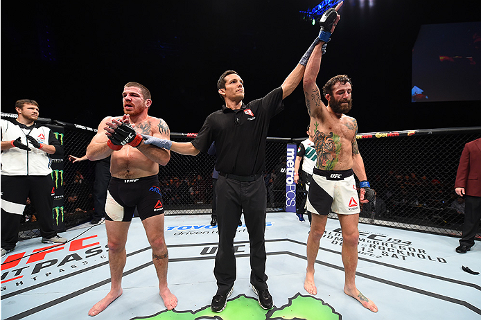 LAS VEGAS, NEVADA - DECEMBER 10: (R) Michael Chiesa celebrates his win over Jim Miller in their lightweight bout during the UFC Fight Night event at The Chelsea at the Cosmopolitan of Las Vegas on December 10, 2015 in Las Vegas, Nevada. (Photo by Jeff B