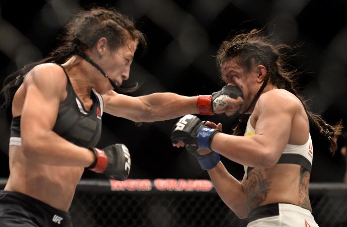LAS VEGAS, NV - JULY 08: (L-R) Joanna Jedrzejczyk of Poland punches Claudia Gadelha of Brazil in their women's strawweight championship bout during The Ultimate Fighter Finale event at MGM Grand Garden Arena on July 8, 2016 in Las Vegas, Nevada. (Photo