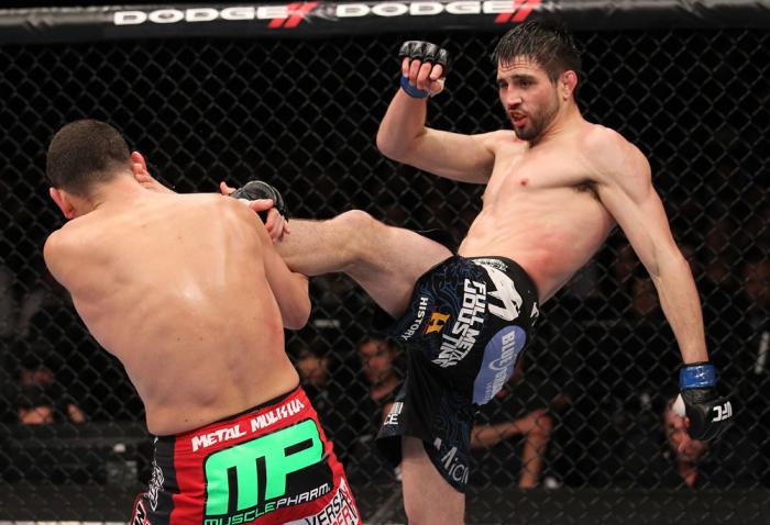 LAS VEGAS - FEBRUARY 04: (R-L) Carlos Condit kicks Nick Diaz during the UFC 143 event at Mandalay Bay Events Center on February 4, 2012 in Las Vegas, Nevada. (Photo by Nick Laham/Zuffa LLC/Zuffa LLC via Getty Images) *** Local Caption *** Carlos Condit;
