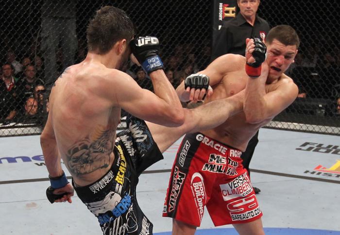 LAS VEGAS - FEBRUARY 04: Carlos Condit (left) kicks Nick Diaz during the UFC 143 event at Mandalay Bay Events Center on February 4, 2012 in Las Vegas, Nevada. (Photo by Nick Laham/Zuffa LLC/Zuffa LLC via Getty Images) *** Local Caption *** Carlos Condit