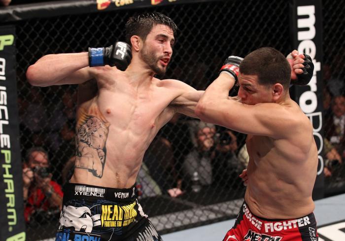 LAS VEGAS - FEBRUARY 04: Carlos Condit (left) punches Nick Diaz during the UFC 143 event at Mandalay Bay Events Center on February 4, 2012 in Las Vegas, Nevada. (Photo by Nick Laham/Zuffa LLC/Zuffa LLC via Getty Images) *** Local Caption *** Carlos Cond