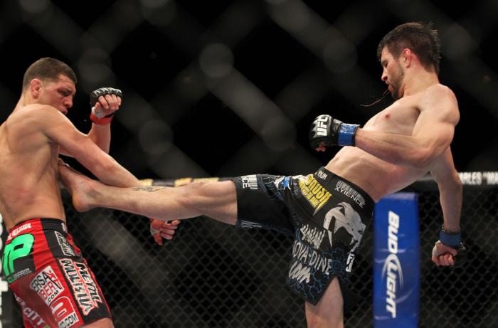 LAS VEGAS - FEBRUARY 04: (R-L) Carlos Condit kicks Nick Diaz during the UFC 143 event at Mandalay Bay Events Center on February 4, 2012 in Las Vegas, Nevada. (Photo by Josh Hedges/Zuffa LLC/Zuffa LLC via Getty Images) *** Local Caption *** Carlos Condit
