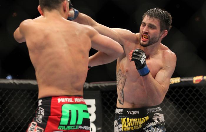 LAS VEGAS - FEBRUARY 04: Carlos Condit (right) punches Nick Diaz during the UFC 143 event at Mandalay Bay Events Center on February 4, 2012 in Las Vegas, Nevada. (Photo by Josh Hedges/Zuffa LLC/Zuffa LLC via Getty Images) *** Local Caption *** Carlos Co