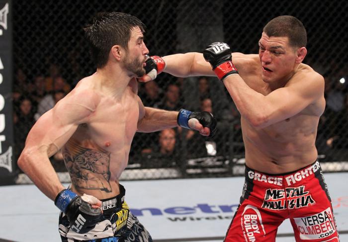 LAS VEGAS - FEBRUARY 04: (R-L) Nick Diaz punches Carlos Condit during the UFC 143 event at Mandalay Bay Events Center on February 4, 2012 in Las Vegas, Nevada. (Photo by Nick Laham/Zuffa LLC/Zuffa LLC via Getty Images) *** Local Caption *** Carlos Condi