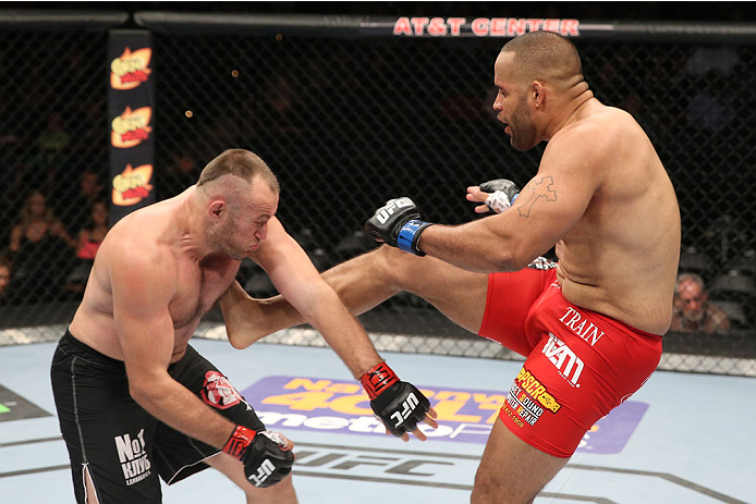 SAN ANTONIO, TX - JUNE 28: (R-L) Oleksiy Oliynyk kicks Anthony Hamilton in their heavyweight bout at the AT&T Center on June 28, 2014 in San Antonio, Texas. (Photo by Ed Mulholland/Zuffa LLC/Zuffa LLC via Getty Images)