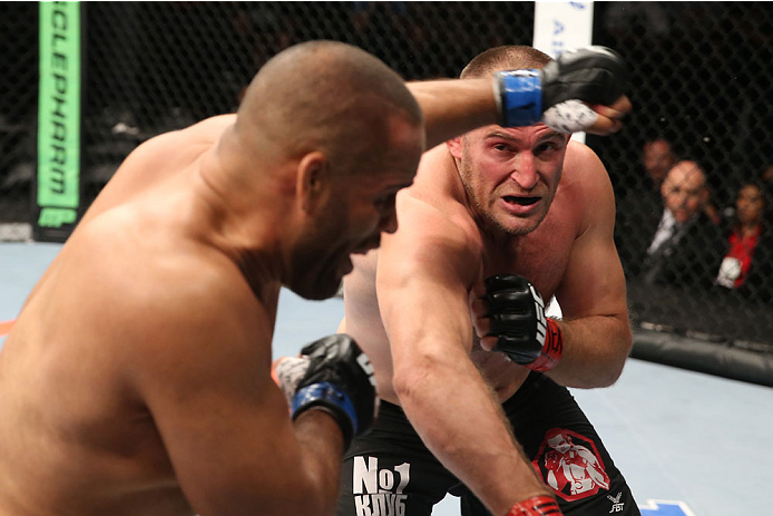 SAN ANTONIO, TX - JUNE 28: (R-L) Oleksiy Oliynyk punches Anthony Hamilton in their heavyweight bout at the AT&T Center on June 28, 2014 in San Antonio, Texas. (Photo by Ed Mulholland/Zuffa LLC/Zuffa LLC via Getty Images)