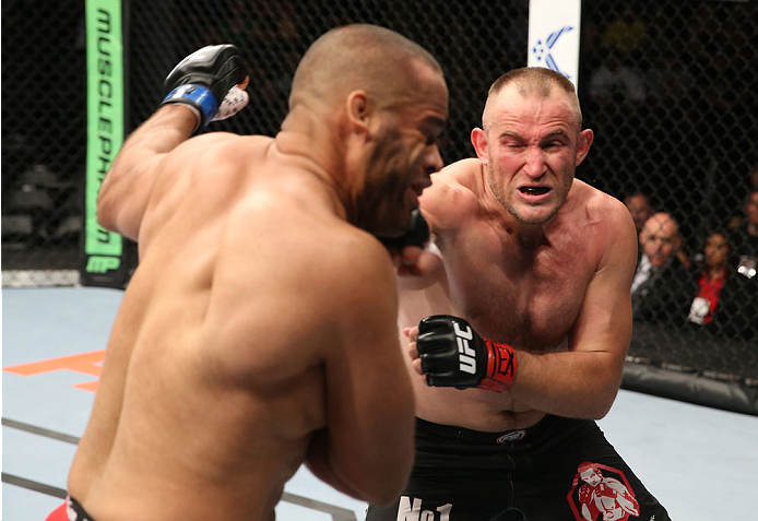 SAN ANTONIO, TX - JUNE 28: (R-L) Oleksiy Oliynyk punches Anthony Hamilton in their heavyweight bout at the AT&T Center on June 28, 2014 in San Antonio, Texas. (Photo by Ed Mulholland/Zuffa LLC/Zuffa LLC via Getty Images)