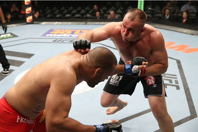 SAN ANTONIO, TX - JUNE 28: (R-L) Oleksiy Oliynyk punches Anthony Hamilton in their heavyweight bout at the AT&T Center on June 28, 2014 in San Antonio, Texas. (Photo by Ed Mulholland/Zuffa LLC/Zuffa LLC via Getty Images)
