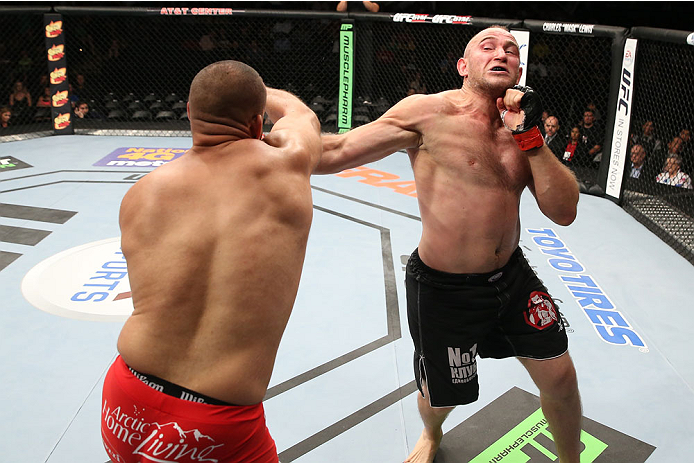 SAN ANTONIO, TX - JUNE 28: (R-L) Oleksiy Oliynyk punches Anthony Hamilton in their heavyweight bout at the AT&T Center on June 28, 2014 in San Antonio, Texas. (Photo by Ed Mulholland/Zuffa LLC/Zuffa LLC via Getty Images)