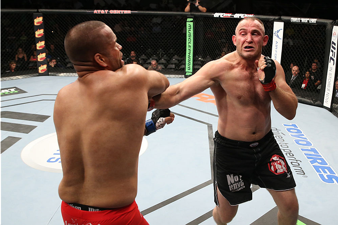 SAN ANTONIO, TX - JUNE 28: (R-L) Oleksiy Oliynyk punches Anthony Hamilton in their heavyweight bout at the AT&T Center on June 28, 2014 in San Antonio, Texas. (Photo by Ed Mulholland/Zuffa LLC/Zuffa LLC via Getty Images)