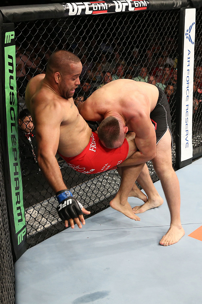 SAN ANTONIO, TX - JUNE 28: Oleksiy Oliynyk (black shorts) takes down Anthony Hamilton in their heavyweight bout at the AT&T Center on June 28, 2014 in San Antonio, Texas. (Photo by Ed Mulholland/Zuffa LLC/Zuffa LLC via Getty Images)