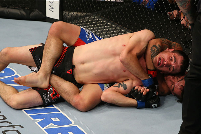 SAN ANTONIO, TX - JUNE 28: Ray Borg (blue shorts) attempts to submit Shane Howell in their flyweight bout at the AT&T Center on June 28, 2014 in San Antonio, Texas. (Photo by Ed Mulholland/Zuffa LLC/Zuffa LLC via Getty Images)