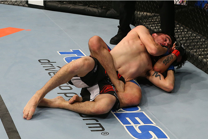 SAN ANTONIO, TX - JUNE 28: Ray Borg attempts to submit Shane Howell (black shorts) in their flyweight bout at the AT&T Center on June 28, 2014 in San Antonio, Texas. (Photo by Ed Mulholland/Zuffa LLC/Zuffa LLC via Getty Images)