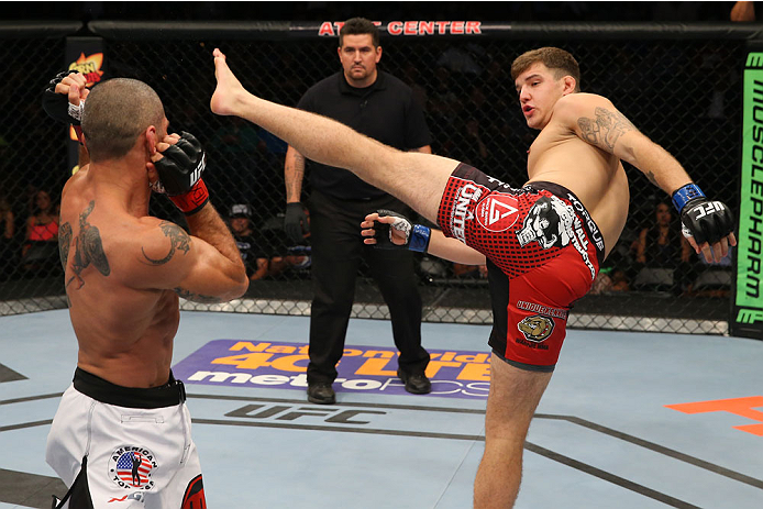 SAN ANTONIO, TX - JUNE 28: (R-L) Andy Enz kicks Marcelo Guimaraes in their middleweight bout at the AT&T Center on June 28, 2014 in San Antonio, Texas. (Photo by Ed Mulholland/Zuffa LLC/Zuffa LLC via Getty Images)