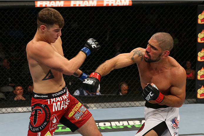 SAN ANTONIO, TX - JUNE 28: (R-L) Marcelo Guimaraes punches Andy Enz in their middleweight bout at the AT&T Center on June 28, 2014 in San Antonio, Texas. (Photo by Ed Mulholland/Zuffa LLC/Zuffa LLC via Getty Images)