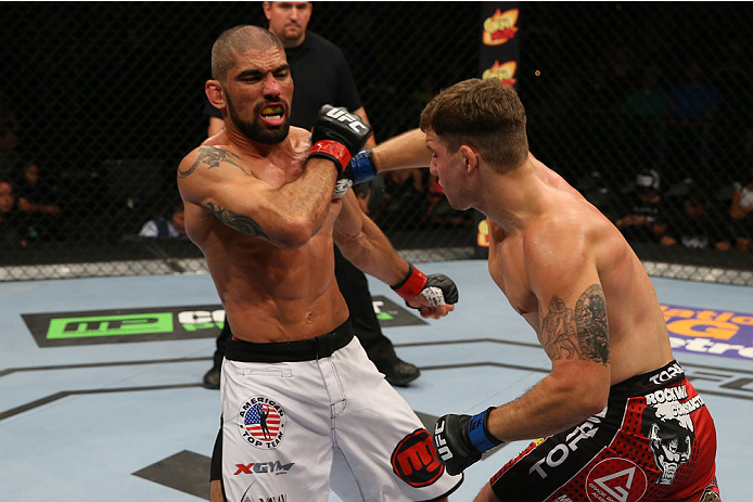 SAN ANTONIO, TX - JUNE 28: (R-L) Andy Enz punches Marcelo Guimaraes in their middleweight bout at the AT&T Center on June 28, 2014 in San Antonio, Texas. (Photo by Ed Mulholland/Zuffa LLC/Zuffa LLC via Getty Images)