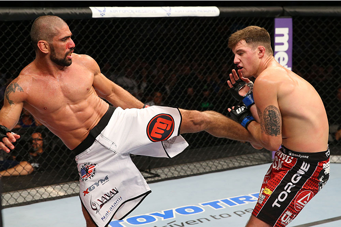 SAN ANTONIO, TX - JUNE 28: (L-R) Marcelo Guimaraes kicks Andy Enz in their middleweight bout at the AT&T Center on June 28, 2014 in San Antonio, Texas. (Photo by Ed Mulholland/Zuffa LLC/Zuffa LLC via Getty Images)