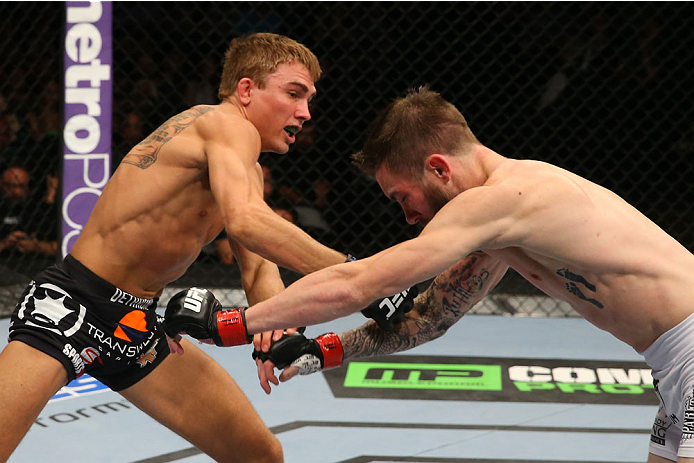 SAN ANTONIO, TX - JUNE 28: (L-R) Cody Gibson punches Johnny Bedford in their bantamweight bout at the AT&T Center on June 28, 2014 in San Antonio, Texas. (Photo by Ed Mulholland/Zuffa LLC/Zuffa LLC via Getty Images)