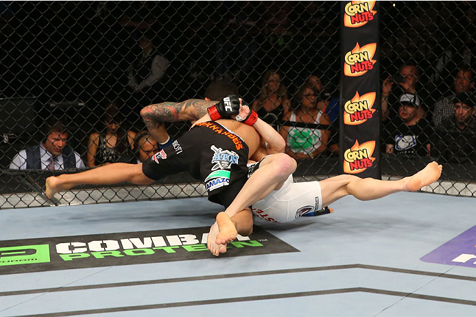 SAN ANTONIO, TX - JUNE 28: Carlos Diego Ferreira (left) slams Colton Smith in their lightweight bout at the AT&T Center on June 28, 2014 in San Antonio, Texas. (Photo by Ed Mulholland/Zuffa LLC/Zuffa LLC via Getty Images)