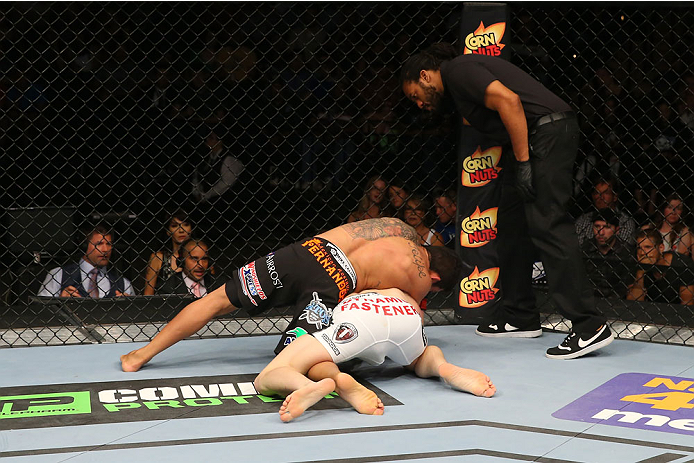 SAN ANTONIO, TX - JUNE 28: Carlos Diego Ferreira (black shorts) attempts to submit Colton Smith (white shorts) as the referee looks on in their lightweight bout at the AT&T Center on June 28, 2014 in San Antonio, Texas. (Photo by Ed Mulholland/Zuffa LLC/