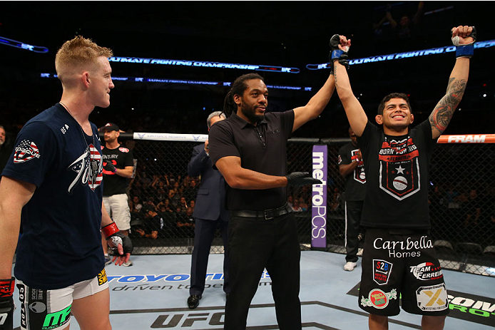 SAN ANTONIO, TX - JUNE 28: Carlos Diego Ferreira (right) reacts to his victory over Colton Smith (left) in their lightweight bout at the AT&T Center on June 28, 2014 in San Antonio, Texas. (Photo by Ed Mulholland/Zuffa LLC/Zuffa LLC via Getty Images)