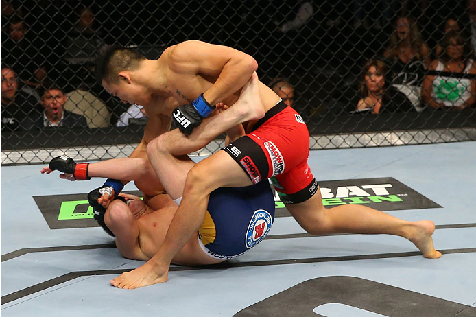 SAN ANTONIO, TX - JUNE 28: James Moontasri (top) punches Joe Ellenberger in their lightweight bout at the AT&T Center on June 28, 2014 in San Antonio, Texas. (Photo by Ed Mulholland/Zuffa LLC/Zuffa LLC via Getty Images)