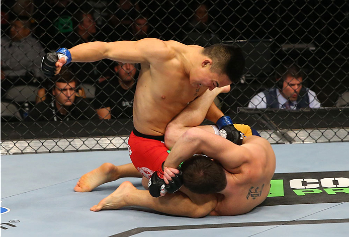 SAN ANTONIO, TX - JUNE 28: (L-R) James Moontasri punches Joe Ellenberger in their lightweight bout at the AT&T Center on June 28, 2014 in San Antonio, Texas. (Photo by Ed Mulholland/Zuffa LLC/Zuffa LLC via Getty Images)