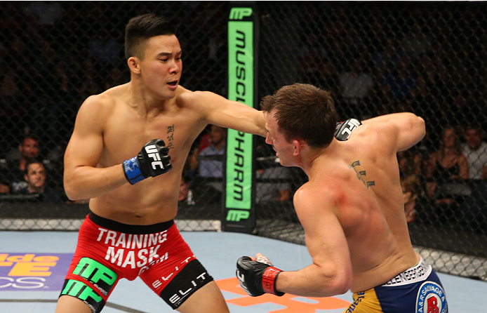 SAN ANTONIO, TX - JUNE 28: (L-R) James Moontasri punches Joe Ellenberger in their lightweight bout at the AT&T Center on June 28, 2014 in San Antonio, Texas. (Photo by Ed Mulholland/Zuffa LLC/Zuffa LLC via Getty Images)