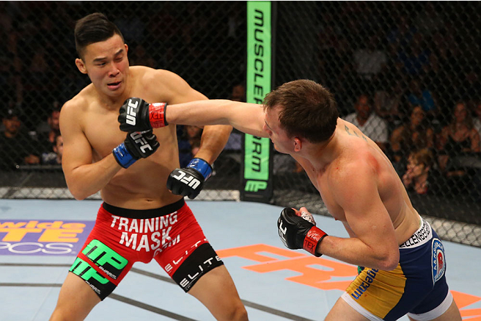 SAN ANTONIO, TX - JUNE 28: (R-L) Joe Ellenberger punches James Moontasri in their lightweight bout at the AT&T Center on June 28, 2014 in San Antonio, Texas. (Photo by Ed Mulholland/Zuffa LLC/Zuffa LLC via Getty Images)