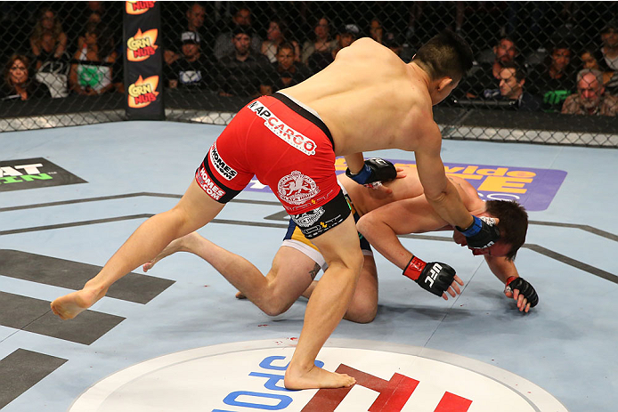 SAN ANTONIO, TX - JUNE 28: James Moontasri (left) punches Joe Ellenberger in their lightweight bout at the AT&T Center on June 28, 2014 in San Antonio, Texas. (Photo by Ed Mulholland/Zuffa LLC/Zuffa LLC via Getty Images)