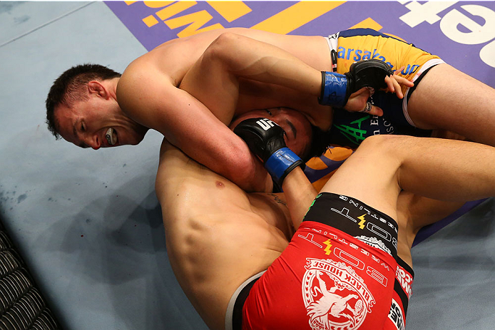 SAN ANTONIO, TX - JUNE 28: Joe Ellenberger (top) attempts to submit James Moontasri in their lightweight bout at the AT&T Center on June 28, 2014 in San Antonio, Texas. (Photo by Ed Mulholland/Zuffa LLC/Zuffa LLC via Getty Images)