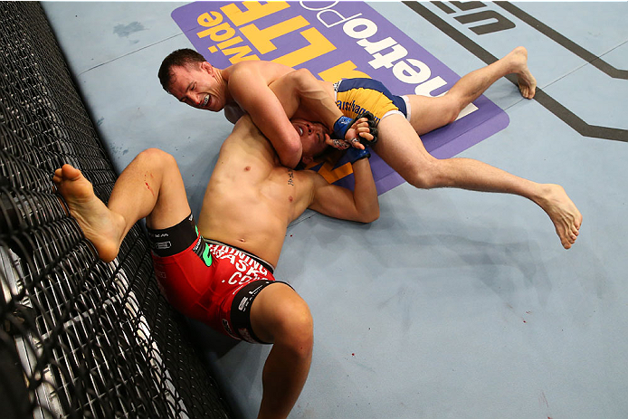 SAN ANTONIO, TX - JUNE 28: Joe Ellenberger (top) attempts to submit James Moontasri in their lightweight bout at the AT&T Center on June 28, 2014 in San Antonio, Texas. (Photo by Ed Mulholland/Zuffa LLC/Zuffa LLC via Getty Images)