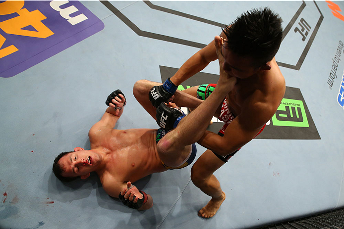 SAN ANTONIO, TX - JUNE 28: Joe Ellenberger (left) kicks James Moontasri in their lightweight bout at the AT&T Center on June 28, 2014 in San Antonio, Texas. (Photo by Ed Mulholland/Zuffa LLC/Zuffa LLC via Getty Images)