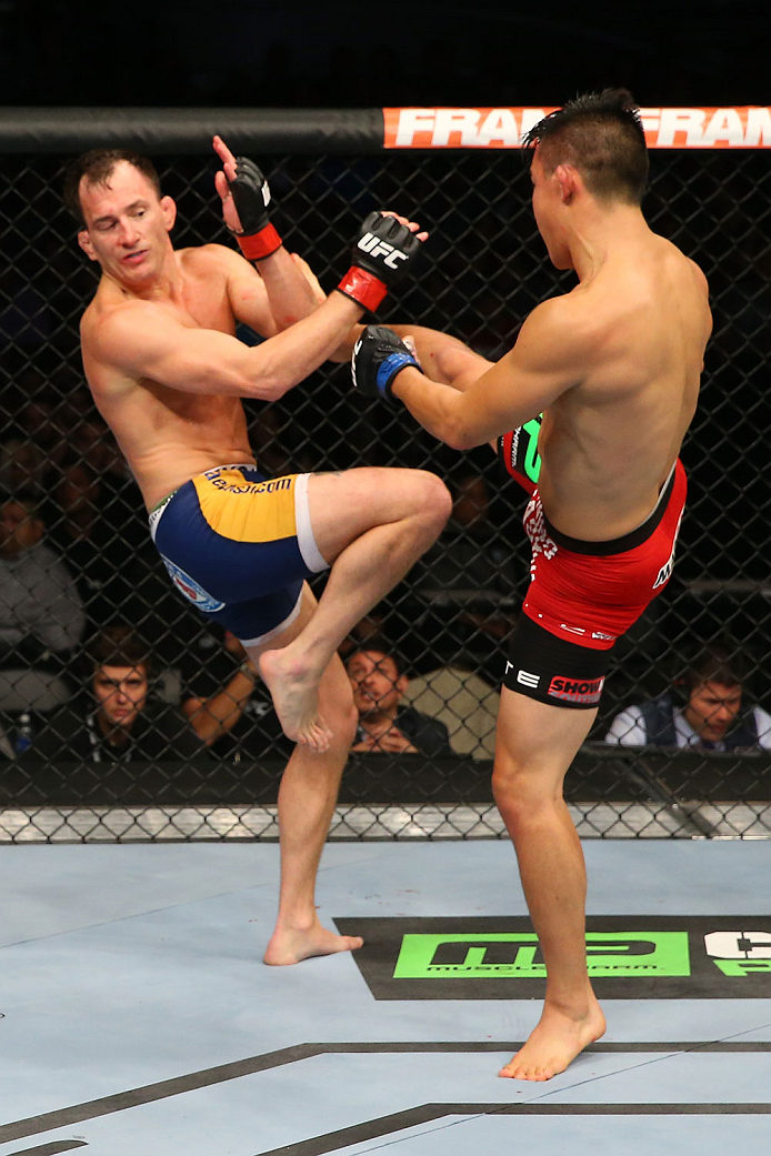 SAN ANTONIO, TX - JUNE 28: (R-L) James Moontasri kicks Joe Ellenberger in their lightweight bout at the AT&T Center on June 28, 2014 in San Antonio, Texas. (Photo by Ed Mulholland/Zuffa LLC/Zuffa LLC via Getty Images)