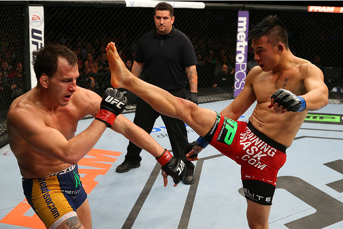 SAN ANTONIO, TX - JUNE 28: (R-L) James Moontasri kicks Joe Ellenberger in their lightweight bout at the AT&T Center on June 28, 2014 in San Antonio, Texas. (Photo by Ed Mulholland/Zuffa LLC/Zuffa LLC via Getty Images)