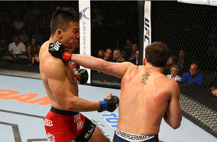 SAN ANTONIO, TX - JUNE 28: (R-L) Joe Ellenberger punches James Moontasri in their lightweight bout at the AT&T Center on June 28, 2014 in San Antonio, Texas. (Photo by Ed Mulholland/Zuffa LLC/Zuffa LLC via Getty Images)