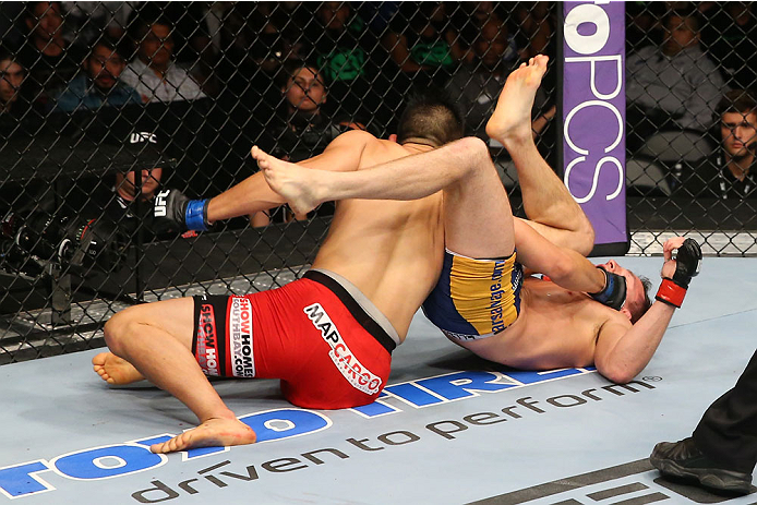SAN ANTONIO, TX - JUNE 28: James Moontasri (red shorts) punches Joe Ellenberger (blue shorts) in their lightweight bout at the AT&T Center on June 28, 2014 in San Antonio, Texas. (Photo by Ed Mulholland/Zuffa LLC/Zuffa LLC via Getty Images)