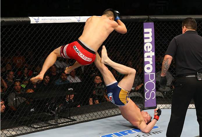 SAN ANTONIO, TX - JUNE 28: James Moontasri (red shorts) delivers an elbow drop to Joe Ellenberger (blue shorts) in their lightweight bout at the AT&T Center on June 28, 2014 in San Antonio, Texas. (Photo by Ed Mulholland/Zuffa LLC/Zuffa LLC via Getty Ima