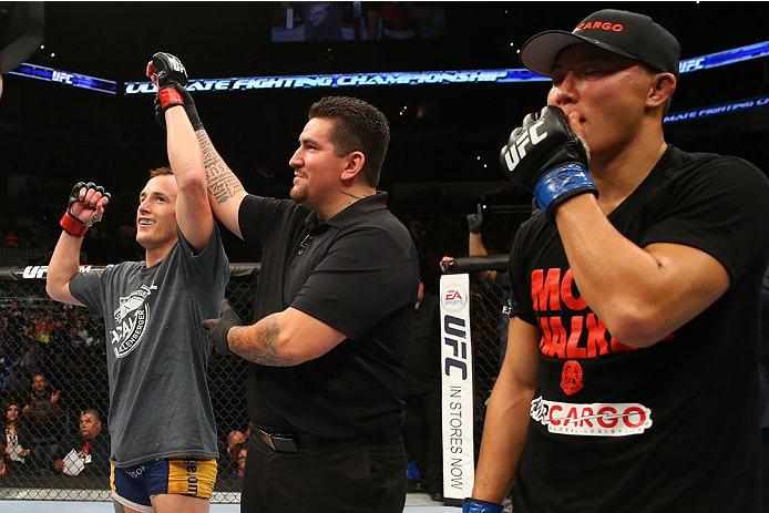 SAN ANTONIO, TX - JUNE 28: Joe Ellenberger (left) reacts to his victory over James Moontasri (right) in their lightweight bout at the AT&T Center on June 28, 2014 in San Antonio, Texas. (Photo by Ed Mulholland/Zuffa LLC/Zuffa LLC via Getty Images)