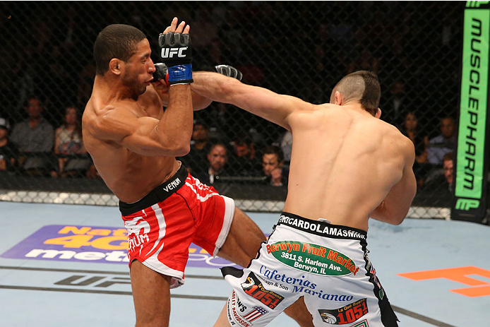 SAN ANTONIO, TX - JUNE 28: (R-L) Ricardo Lamas punches Hacran Dias in their featherweight bout at the AT&T Center on June 28, 2014 in San Antonio, Texas. (Photo by Ed Mulholland/Zuffa LLC/Zuffa LLC via Getty Images)