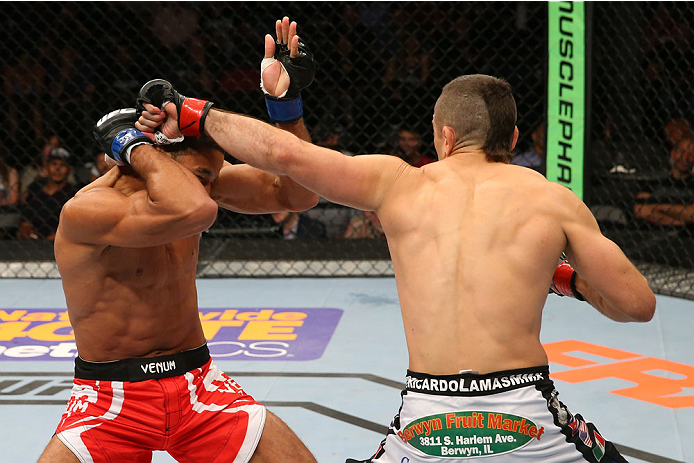 SAN ANTONIO, TX - JUNE 28: (R-L) Ricardo Lamas punches Hacran Dias in their featherweight bout at the AT&T Center on June 28, 2014 in San Antonio, Texas. (Photo by Ed Mulholland/Zuffa LLC/Zuffa LLC via Getty Images)