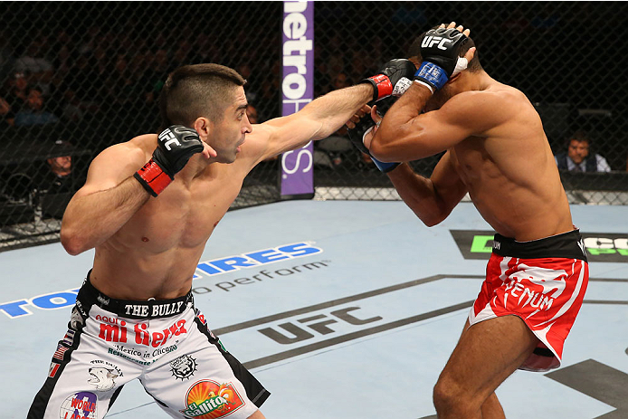 SAN ANTONIO, TX - JUNE 28: (L-R) Ricardo Lamas punches Hacran Dias in their featherweight bout at the AT&T Center on June 28, 2014 in San Antonio, Texas. (Photo by Ed Mulholland/Zuffa LLC/Zuffa LLC via Getty Images)