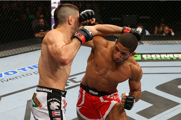 SAN ANTONIO, TX - JUNE 28: (R-L) Hacran Dias punches Ricardo Lamas in their featherweight bout at the AT&T Center on June 28, 2014 in San Antonio, Texas. (Photo by Ed Mulholland/Zuffa LLC/Zuffa LLC via Getty Images)