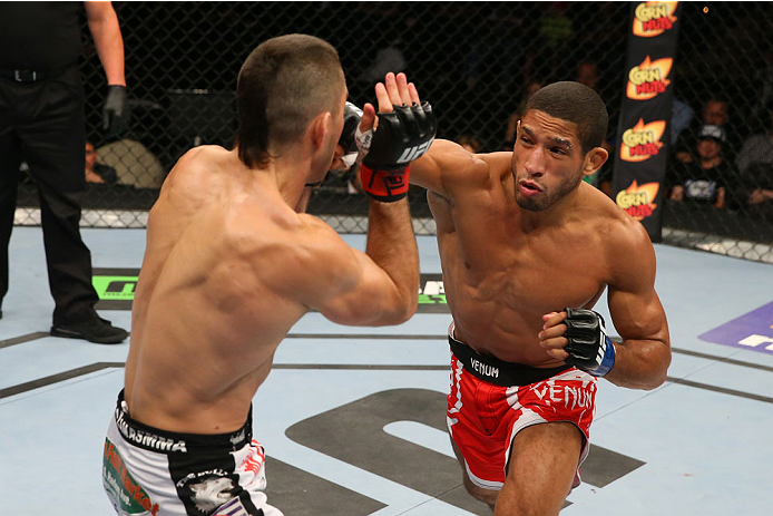 SAN ANTONIO, TX - JUNE 28: (R-L) Hacran Dias punches Ricardo Lamas in their featherweight bout at the AT&T Center on June 28, 2014 in San Antonio, Texas. (Photo by Ed Mulholland/Zuffa LLC/Zuffa LLC via Getty Images)
