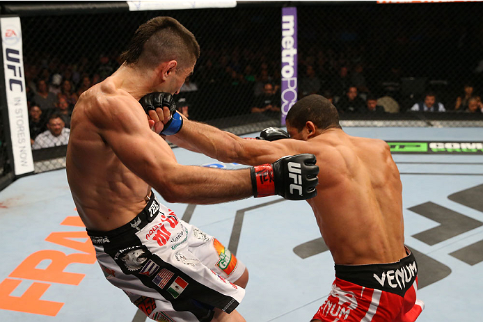 SAN ANTONIO, TX - JUNE 28: (R-L) Hacran Dias punches Ricardo Lamas in their featherweight bout at the AT&T Center on June 28, 2014 in San Antonio, Texas. (Photo by Ed Mulholland/Zuffa LLC/Zuffa LLC via Getty Images)