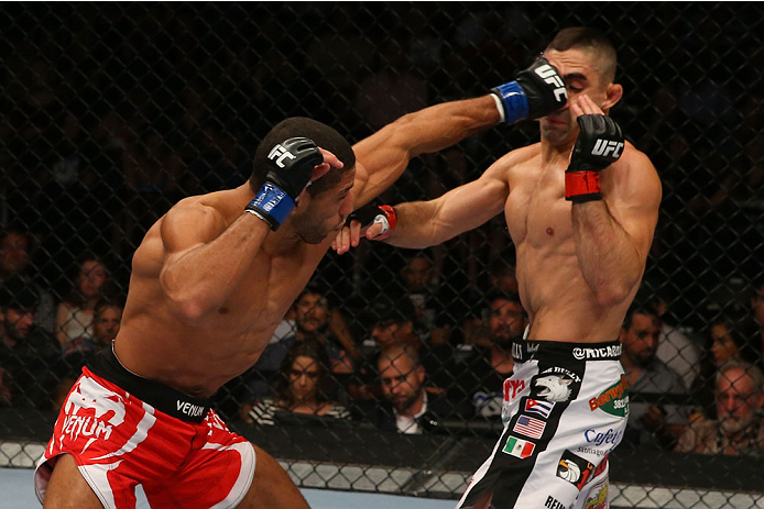 SAN ANTONIO, TX - JUNE 28: (L-R) Hacran Dias punches Ricardo Lamas in their featherweight bout at the AT&T Center on June 28, 2014 in San Antonio, Texas. (Photo by Ed Mulholland/Zuffa LLC/Zuffa LLC via Getty Images)