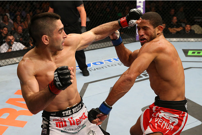 SAN ANTONIO, TX - JUNE 28: (L-R) Ricardo Lamas punches Hacran Dias in their featherweight bout at the AT&T Center on June 28, 2014 in San Antonio, Texas. (Photo by Ed Mulholland/Zuffa LLC/Zuffa LLC via Getty Images)