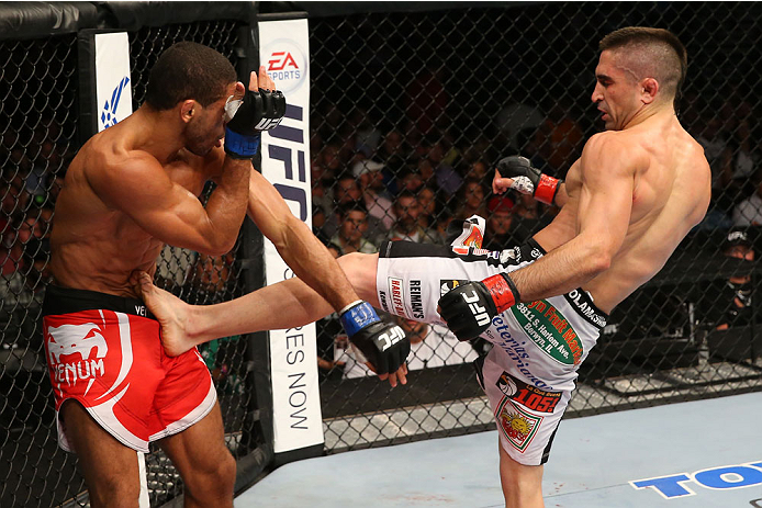 SAN ANTONIO, TX - JUNE 28: (R-L) Ricardo Lamas kicks Hacran Dias in their featherweight bout at the AT&T Center on June 28, 2014 in San Antonio, Texas. (Photo by Ed Mulholland/Zuffa LLC/Zuffa LLC via Getty Images)