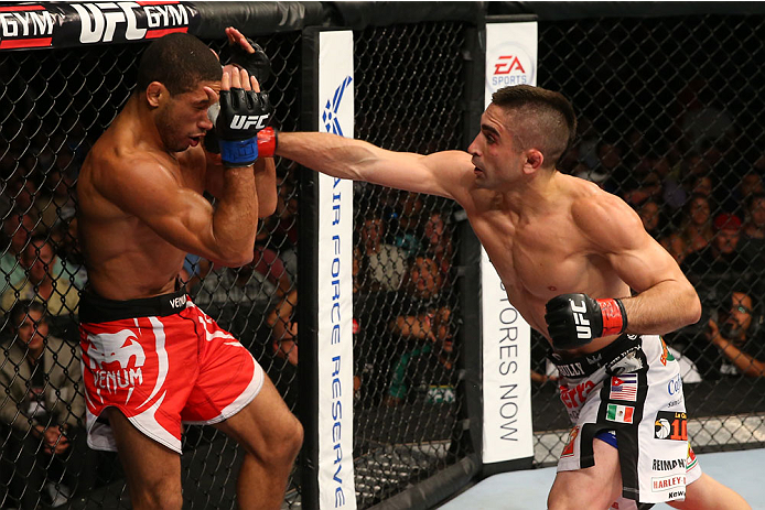 SAN ANTONIO, TX - JUNE 28: (R-L) Ricardo Lamas punches Hacran Dias in their featherweight bout at the AT&T Center on June 28, 2014 in San Antonio, Texas. (Photo by Ed Mulholland/Zuffa LLC/Zuffa LLC via Getty Images)